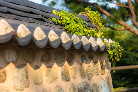 Close up shot of tiled roof stone wall fenceの写真素材