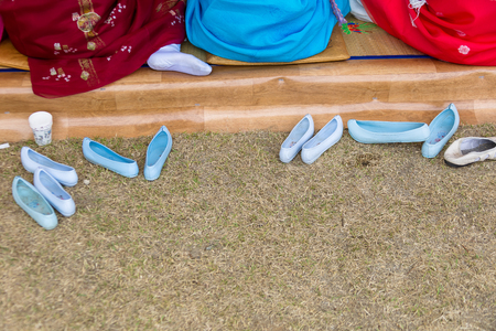 Korea Danoje - White rubber shoes placed on grass groundの写真素材