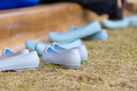 Korea Danoje - White rubber shoes placed on grass groundの写真素材