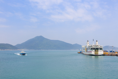 Slow city island-Boat sailing in the emerald color seaのeditorial素材