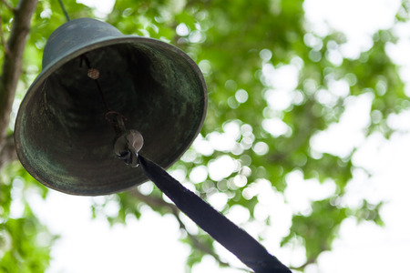 Old wind bell hanging from a treeの写真素材