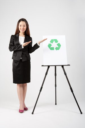 Female Asian in business suit posing with recycle symbolの写真素材