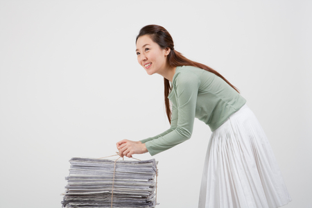 Female asian with recycle materials posing - isolated in white background studioの写真素材