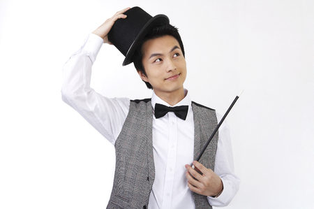 Male Asian in suit posing in a studio with magic toolsの写真素材