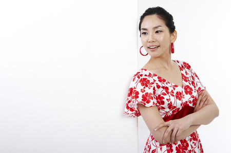 Female Asian in dress posing in a studioの写真素材