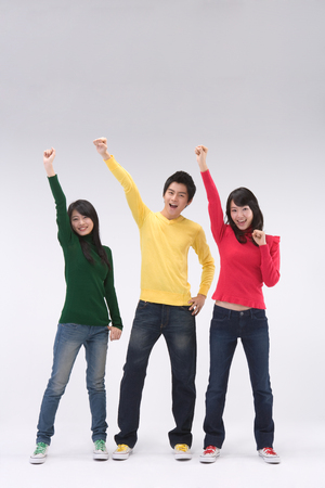 Two Asian women and a man posing in a studioの写真素材