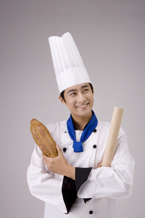 Male chef/cook posing in a studio with breadの写真素材