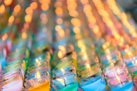 Close up shot of lit colorful holy candlesの写真素材