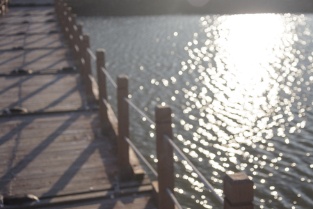 Close up shot of wooden bridge linking to rock island at low tideの写真素材