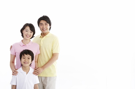 Asian parents and son posing in a studioの写真素材