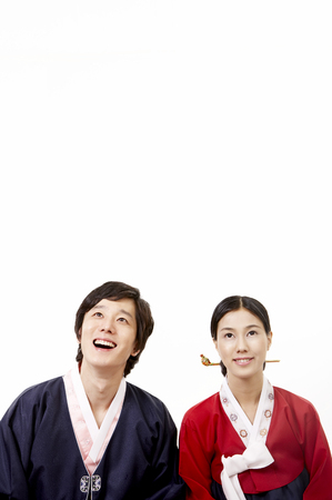 Asian couple wearing traditional korean costume posing in a studioの写真素材