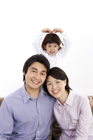 Parents and daughter posing in a studioの写真素材