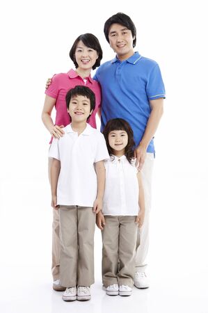 Parents and two children posing together isolated in whiteの写真素材