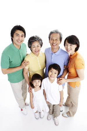 Three generations of Asian family posing in a studio as standing upの写真素材