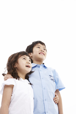 Cloes up shot of Young Asian boy and girl posing together in a studioの写真素材