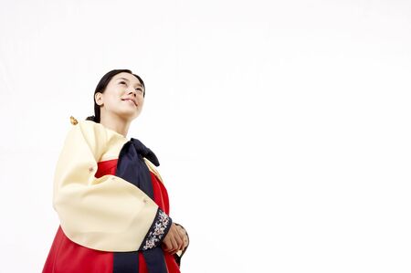 Korean woman wearing traditional costume posing in a studioの写真素材