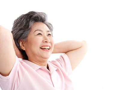 Female Asian elderly posing in a studio with hand gestureの写真素材