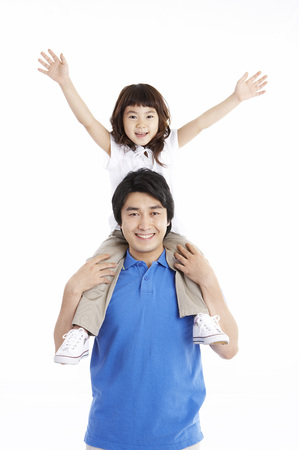 Asian father carrying daughter isolated in whiteの写真素材