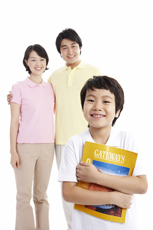 Asian parents and son posing in a studio with English bookの写真素材