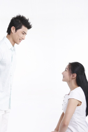 Asian couple in white outfit posing in clear white studioの写真素材