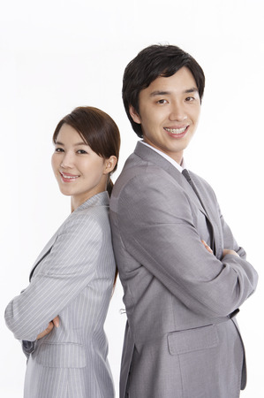Asian man and woman in business suit posing in a studio with gestureの写真素材