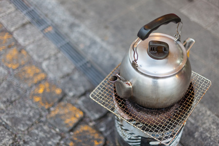 Korean temple - Stainless kettle on the briquette stoveの写真素材