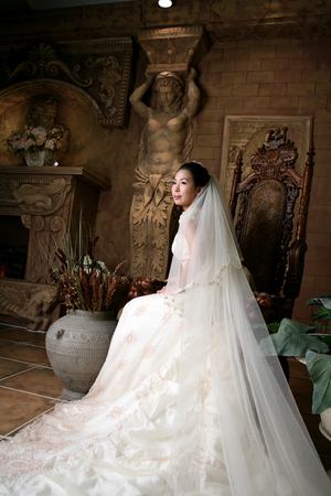 Asian bride in wedding dresses posing in antique background studioの写真素材