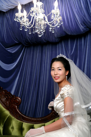 Close up shot of Asian bride in wedding dresses posing in a studioの写真素材