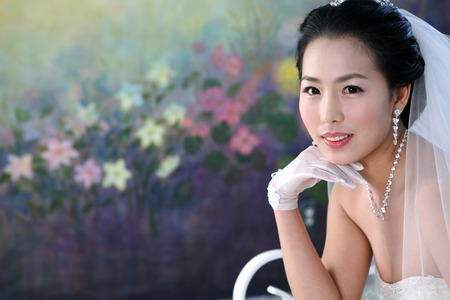Close up shot of Asian bride in wedding dresses posing in a studioの写真素材