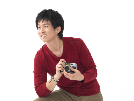 Asian man posing in a studio with cameraのeditorial素材