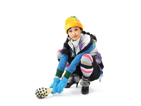 Young Asian female fashion model posing in a studio as dressed up like a tomboy with a magic horn...