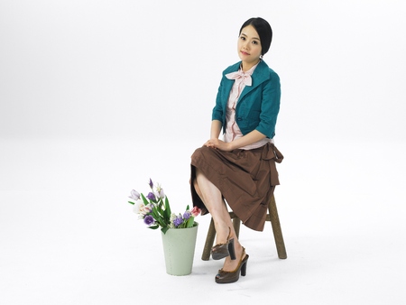 Asian woman fashion model posing in a studio as wearing business formal look skirt outfitの写真素材