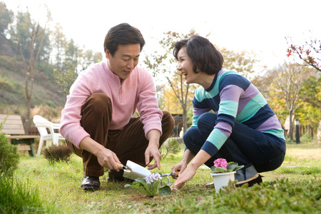 Mid-aged married Asian couple spending time together as gardeningの写真素材