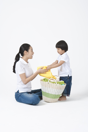 Mother and son spending family time together with laundryの写真素材