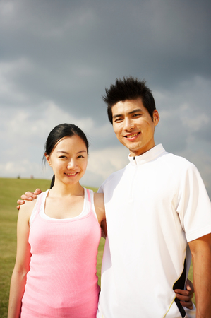 Young Asian couple relaxing in the parkの写真素材