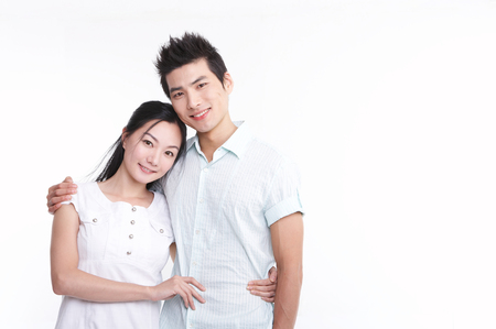 Young Asian couple posing in the studio - isolated on whiteの写真素材