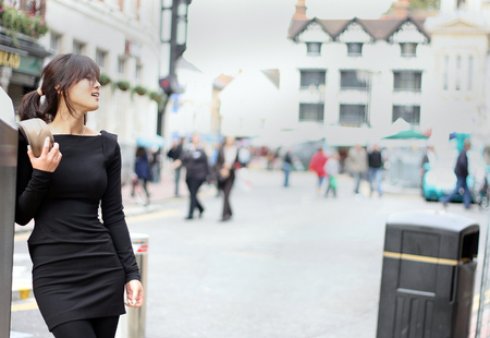 Stylish Asian woman posing in the streetの写真素材
