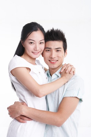 Young Asian couple posing in the studio - isolated on whiteの写真素材