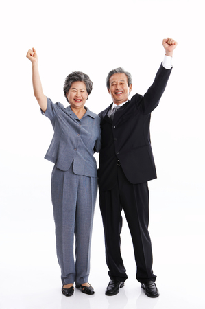 Asian middle aged couple posing in the studio - isolated on whiteの写真素材