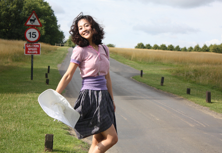 Stylish Asian woman posing in the streetの写真素材
