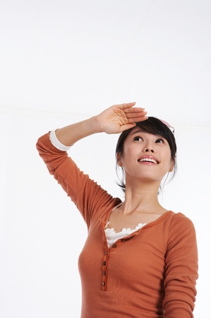 Young Asian woman looking excited to go on a vacation - isolated on whiteの写真素材