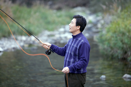 Asian middle aged man enjoying fishing