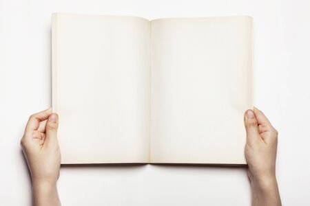 Hands with an empty book - isolated on whiteの写真素材