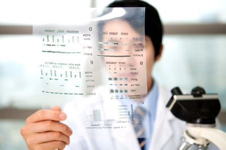 Asian scientist man in protective coat examine the paper