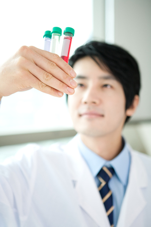 Close up of Asian man doing experimental work in laboratoryの写真素材
