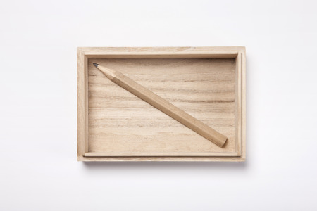 Pencil in a wooden box - isolated on whiteの写真素材