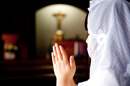 Rear view of Woman praying in churchの写真素材