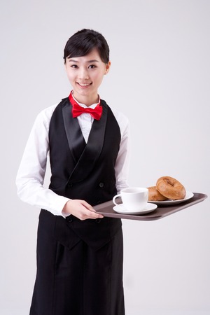 Asian waitress serving dessert isolated on white