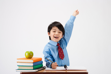 Asian boy ready to answer question isolated on whiteの写真素材