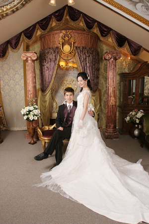 Asian wedding couple having happy time in antique roomの写真素材
